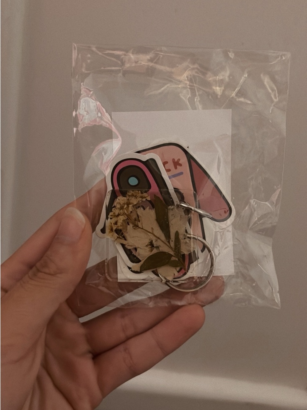 Pink Cartoon Keychain with Floral Accent